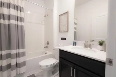 a white bathroom with a sink and a toilet at Private Vacation Home at Storey Lake, Orlando Florida in Kissimmee