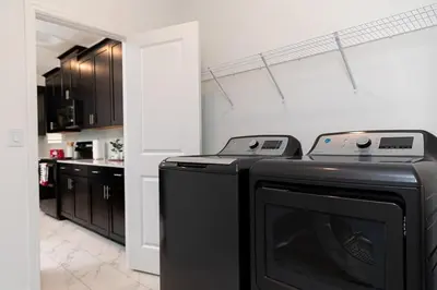 a kitchen with a washer and dryer in a room at Private Vacation Home at Storey Lake, Orlando Florida in Kissimmee