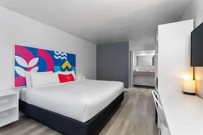 a bedroom with a large bed in a room at Baymont by Wyndham Orlando Lake Buena Vista South in Kissimmee