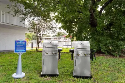 two silver appliances sitting in the grass next to a table at Baymont by Wyndham Orlando Lake Buena Vista South in Kissimmee