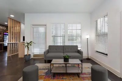 a living room with a couch and a table at Baymont by Wyndham Orlando Lake Buena Vista South in Kissimmee