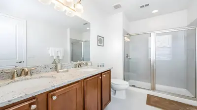 a bathroom with a toilet and a sink and a shower at Elegant Fun Vacation Home at Encore Resort 7529 in Orlando