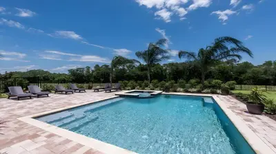 a swimming pool with chaise lounge chairs and a patio at Elegant Fun Vacation Home at Encore Resort 7529 in Orlando