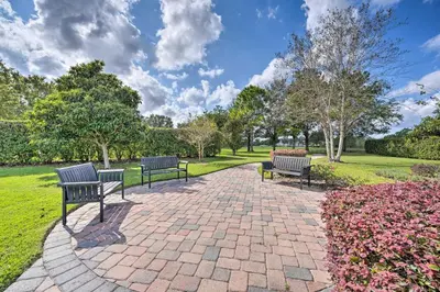 three benches sitting on a brick walkway in a park at 10 Mi to Disney and Heated Pool Florida Abode! in Orlando