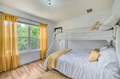a bedroom with two bunk beds and a window at Kissimmee Condo Community Perks, 10 Mi to Disney! in Kissimmee