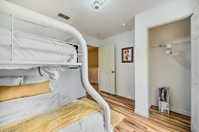 a white bunk bed in a room with wood floors at Kissimmee Condo Community Perks, 10 Mi to Disney! in Kissimmee