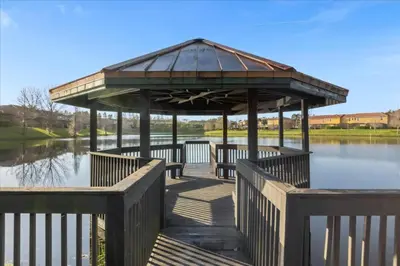 a gazebo on a boardwalk over a lake at 3 Bedrooms 25 Bathrooms Encantada 3091 Yl in Orlando