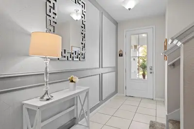a hallway with a console table and a lamp at 7 Bedrooms 65 Bathrooms Solara 9024 Fk in Orlando