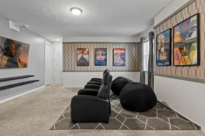 a room with chairs and posters on the wall at 7 Bedrooms 65 Bathrooms Solara 9024 Fk in Orlando