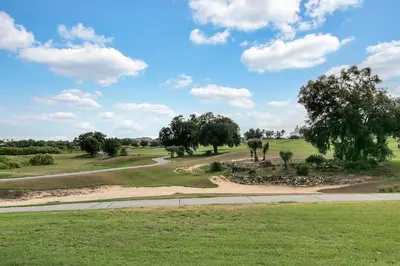 a view of a golf course with trees and a road at 3 Bedrooms 25 Bathrooms Reunion Resort 1589 Hc in Orlando