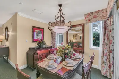 a dining room with a table and chairs and a chandelier at 3 Bedrooms 25 Bathrooms Reunion Resort 1589 Hc in Orlando