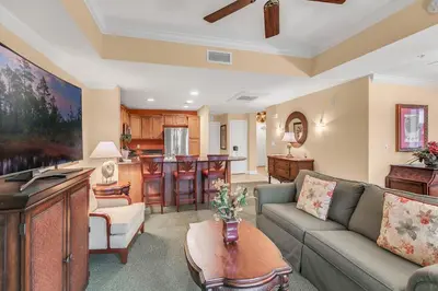 a living room with a couch and a kitchen at 3 Bedrooms 25 Bathrooms Reunion Resort 1589 Hc in Orlando
