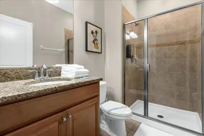 a bathroom with a shower and a toilet and a sink at 4 Bedrooms 3 Bathrooms Storey Lake 3195 Pp in Orlando