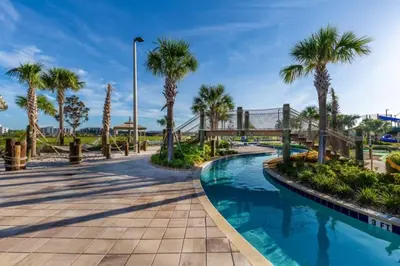 a swimming pool with palm trees and a walkway at 4 Bedrooms 3 Bathrooms Storey Lake 3195 Pp in Orlando