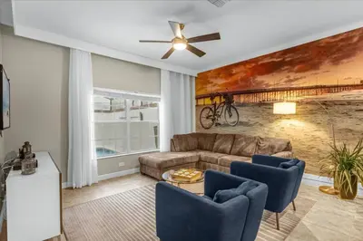 a living room with a couch and a ceiling fan at 4 Bedrooms 3 Bathrooms Storey Lake 3195 Pp in Orlando