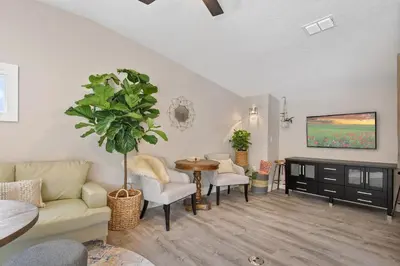 a living room with a couch and a table at 5Bd 4Bath villa, amazing outdoor space, pet friendly in Orlando