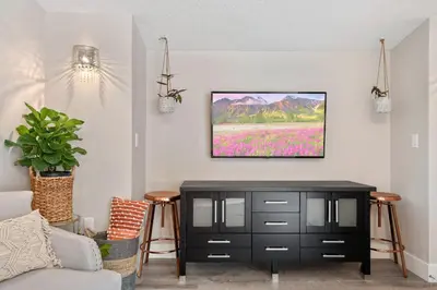 a living room with a tv on a wall at 5Bd 4Bath villa, amazing outdoor space, pet friendly in Orlando