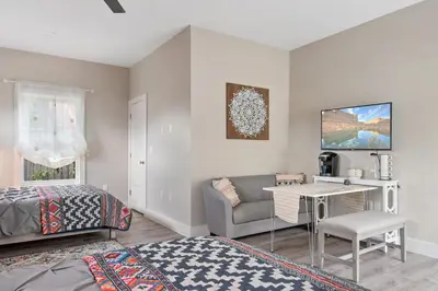 a bedroom with a bed and a couch and a desk at 5Bd 4Bath villa, amazing outdoor space, pet friendly in Orlando