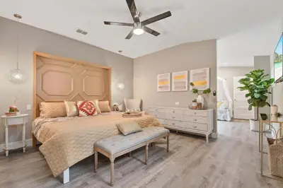 a bedroom with a bed and a ceiling fan at 5Bd 4Bath villa, amazing outdoor space, pet friendly in Orlando