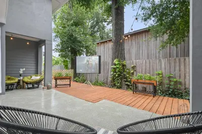 a patio with two chairs and a projection screen at Bohemian Retreat in the Heart of Orlando in Orlando