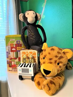 a stuffed monkey sitting on a shelf next to a toy piano at Marvelous Magical House: Amazing Themes and Pool, 5mi Disney in Kissimmee
