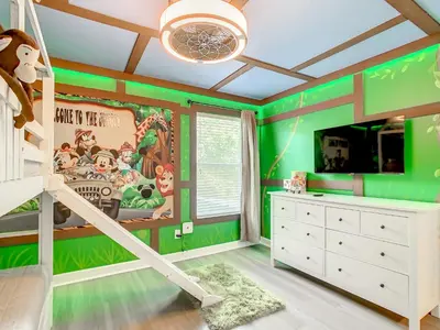 a childs room with green walls and a bunk bed at Marvelous Magical House: Amazing Themes and Pool, 5mi Disney in Kissimmee