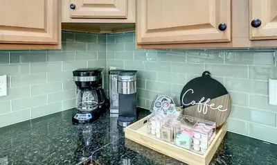 a kitchen counter with a coffee maker on it at Marvelous Magical House: Amazing Themes and Pool, 5mi Disney in Kissimmee