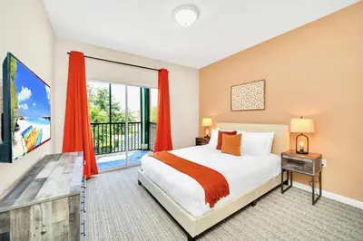 a bedroom with a bed and a large window at 3BR Condo with Pool Close to Disney in Orlando