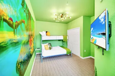 a childs bedroom with green walls and a large painting at 3BR Condo with Pool Close to Disney in Orlando