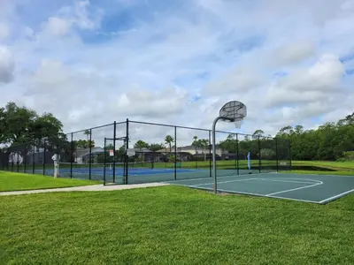 a tennis court with a basketball hoop on it at Fully Renovated, Quiet, Spacious Disney Themed Pool Home with Office in Kissimmee