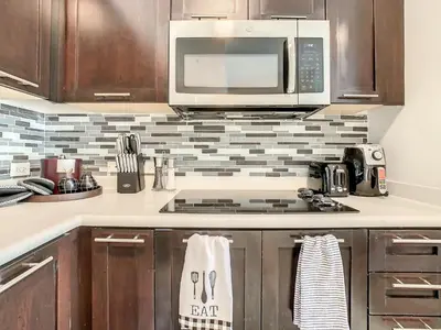 a kitchen with a microwave and a stove top oven at Pet Friendly in Orlando area near Disney in Orlando