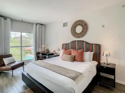 a bedroom with a bed and a chair and a window at Pet Friendly in Orlando area near Disney in Orlando