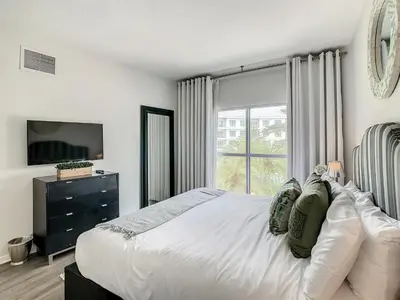 a bedroom with a large bed and a window at Pet Friendly in Orlando area near Disney in Orlando
