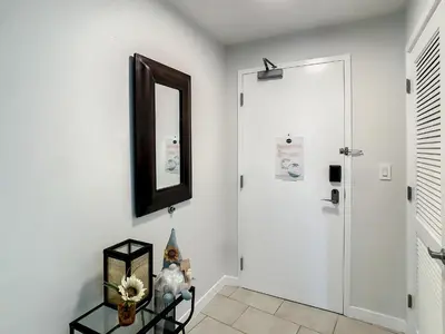 a hallway with a white door and a mirror at Pet Friendly in Orlando area near Disney in Orlando