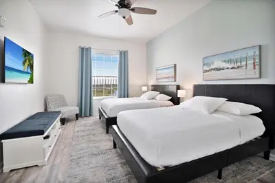 a bedroom with two beds and a ceiling fan at 3 Bed Penthouse Near Convention Center! condo in Orlando