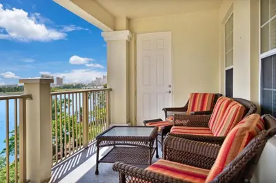 a balcony with chairs and a table and a view of the water at 3 Bed Penthouse Near Convention Center! condo in Orlando