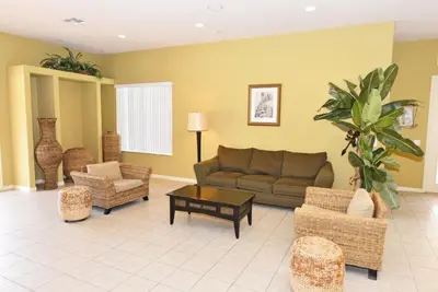 a living room with a couch and a table at Lakeside 4-Bed Pool Home at Villa Sol home in Kissimmee