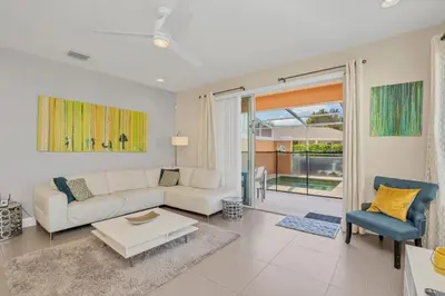 a living room with a couch and a table at 1511RETREAT townhouse in Orlando