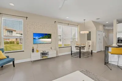 a living room with a kitchen and a dining room at 1511RETREAT townhouse in Orlando