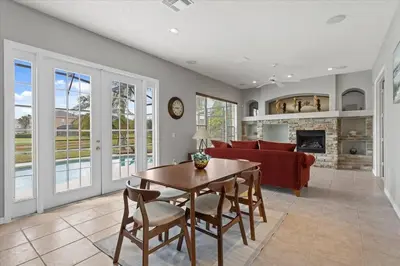 a living room with a table and a couch at LONG STAYS! Lakefront - Gated Pool Home in Orlando