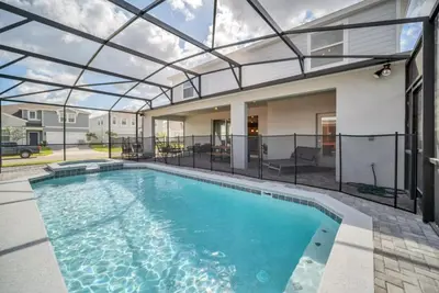 a swimming pool with a glass roof over a house at 8 Bedroom 6 Bathroom Resort Home villa in Kissimmee