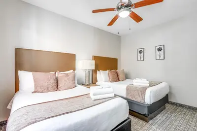 a bedroom with two beds and a ceiling fan at Disney Good Neighbor Resort Condo Less Than 4 Mi to WDW! in Orlando