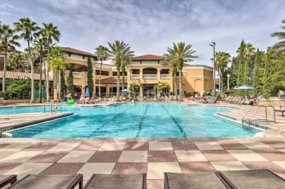 a swimming pool at a resort with palm trees at Disney Good Neighbor Resort Condo Less Than 4 Mi to WDW! in Orlando
