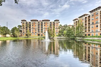 a fountain in a pond in front of a building at Disney Good Neighbor Resort Condo Less Than 4 Mi to WDW! in Orlando
