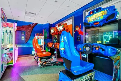 a childs room with a video game arcade at Alluring Home With Private Pool Near Disney With Waterpark Resort Access At Encore Resort - 7732Ff in Kissimmee