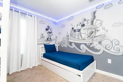 a childs bedroom with a pirate ship mural on the wall at Magnificent 5Bd w/ Pool Close to Disney @Storey Lake 4800 in Kissimmee