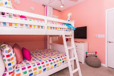 a bunk bed in a bedroom with pink walls at Magical Retreat: Luxurious Home near Disney World in Kissimmee