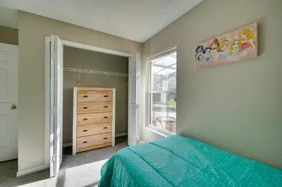 a bedroom with a bed and a window at Kissimmee Getaway with Pool about 7 Mi to Disney! in Kissimmee