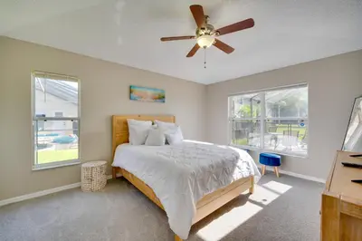 a bedroom with a bed and a ceiling fan at Kissimmee Getaway with Pool about 7 Mi to Disney! in Kissimmee