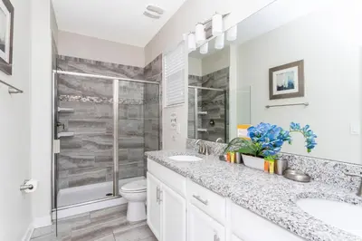 a bathroom with a shower and a sink and a toilet at Blue Moon House in Kissimmee
